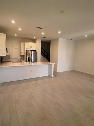 an empty room with kitchen appliances and windows