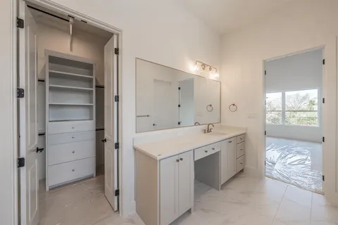 a view of a bathroom with a sink and mirror