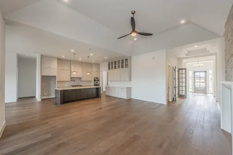 a view of kitchen with sink and refrigerator