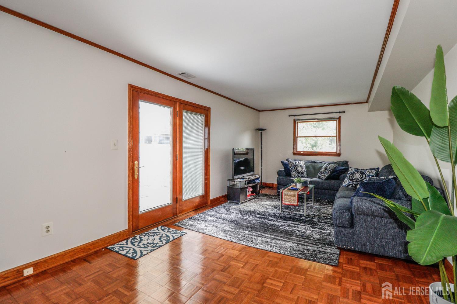 5 Timothy Court Edison, NJ 08837 - Photo 23 of 32 a living room with furniture a window and a flat screen tv