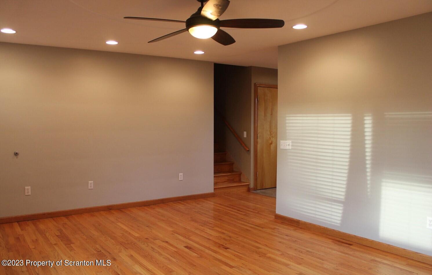 707 Hollenback Street Moosic, PA 18507 - Photo 3 of 20 an empty room with wooden floor and windows
