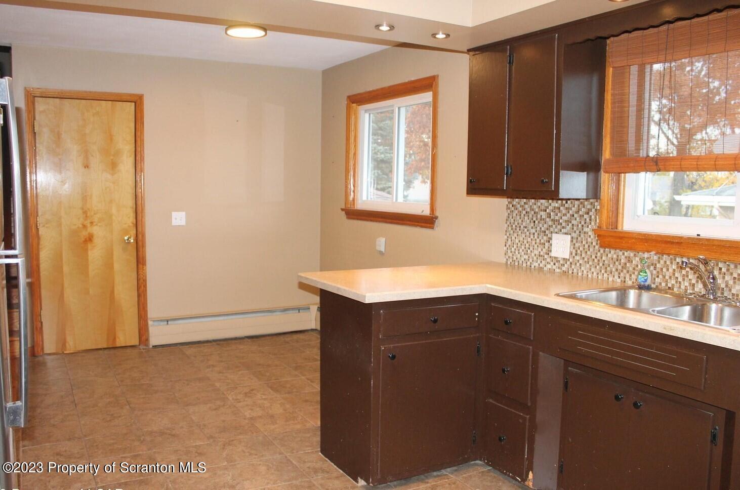 707 Hollenback Street Moosic, PA 18507 - Photo 4 of 20 a kitchen with a sink cabinets and a window
