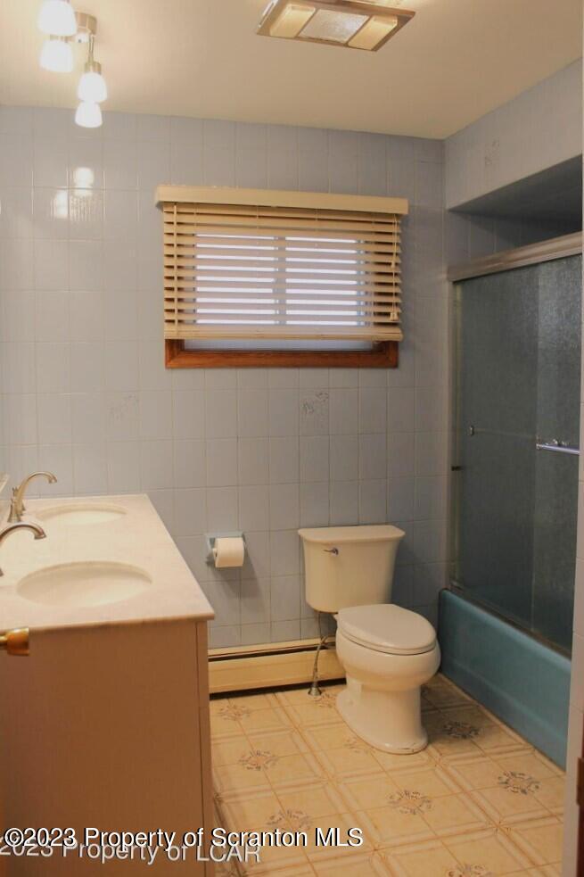 707 Hollenback Street Moosic, PA 18507 - Photo 6 of 20 a bathroom with a toilet a sink and a shower