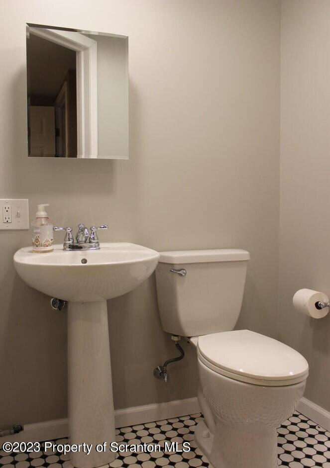 707 Hollenback Street Moosic, PA 18507 - Photo 7 of 20 a white toilet sitting next to a bathroom sink