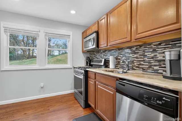 a kitchen with stainless steel appliances granite countertop a stove and a sink