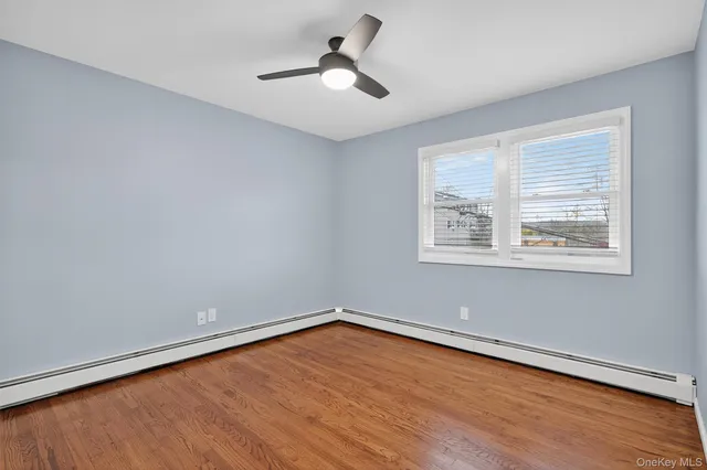 wooden floor in an empty room with a window
