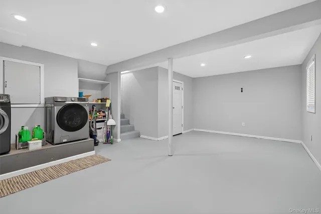 a view of a storage & utility room with two washing machine