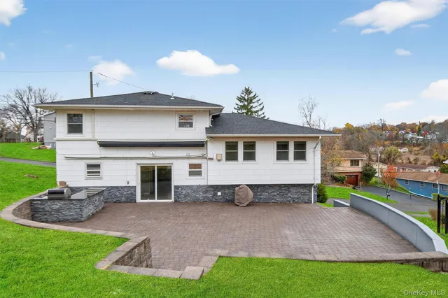 a view of house with a yard