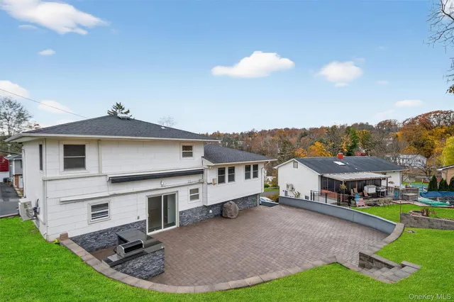 a view of a house with a yard porch and sitting area