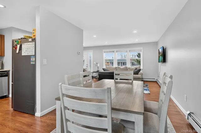 a dining room with furniture and wooden floor