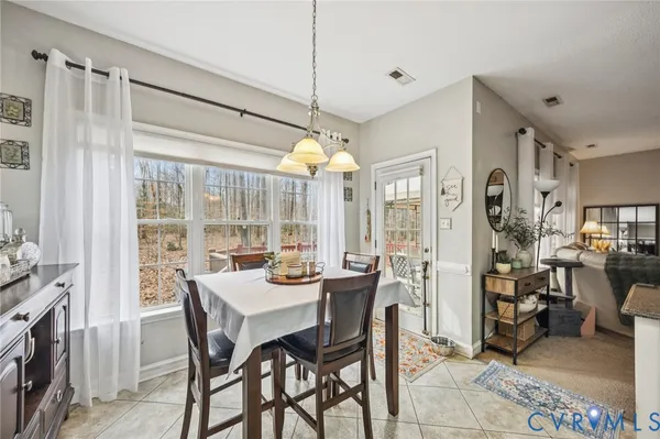 a kitchen with sink a stove and chairs