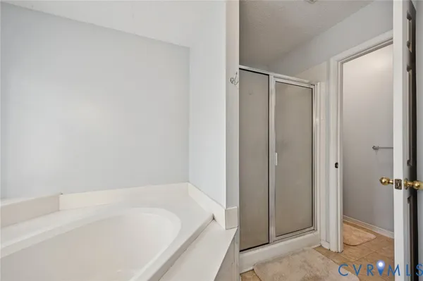 a bathroom with a double vanity sink mirror and bathtub
