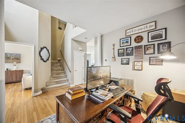 a view of a workspace with furniture and wooden floor