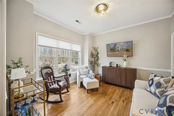 a living room with furniture and wooden floor