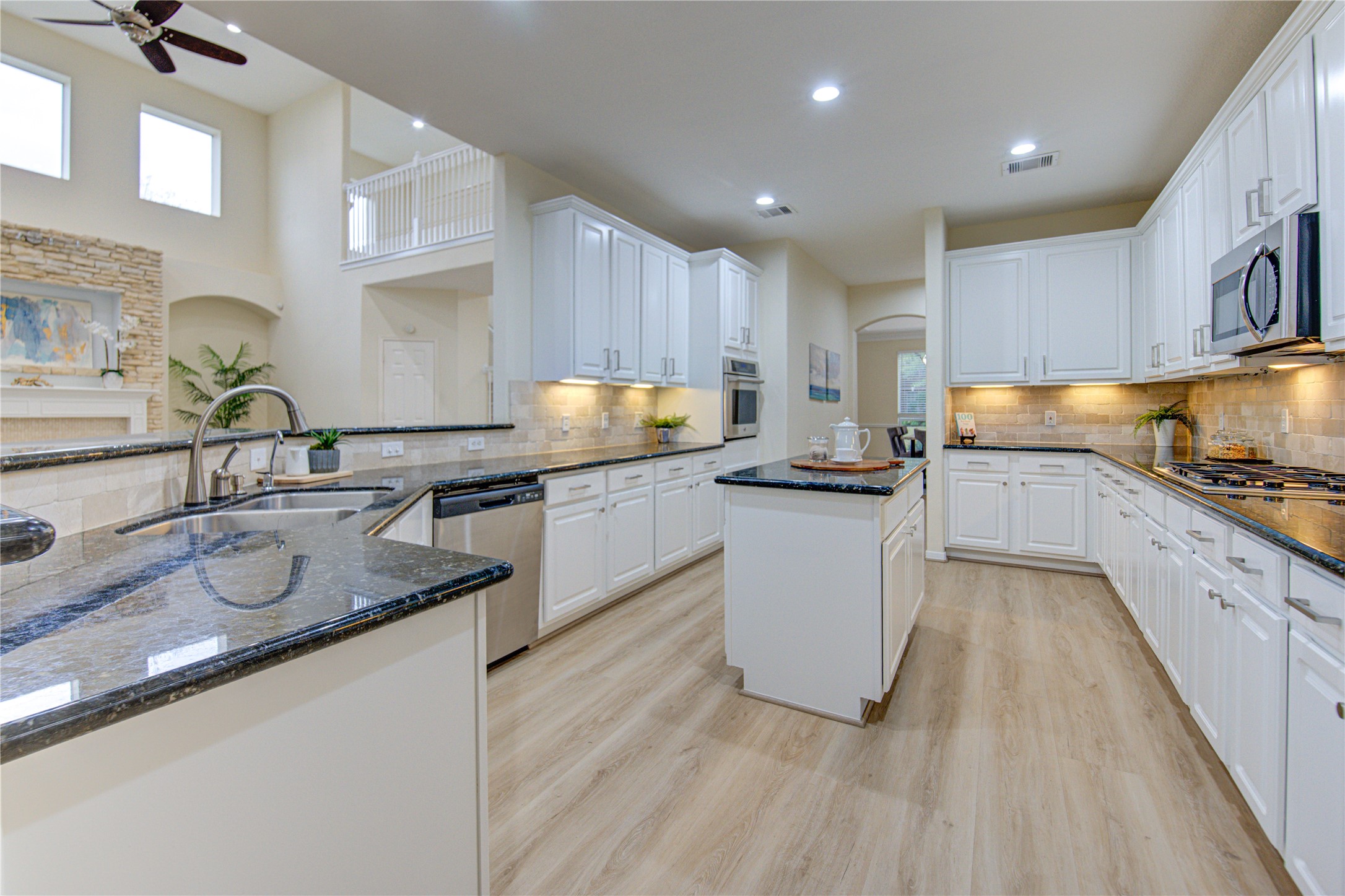 2327 Centerbrook Lane Katy, TX 77450 - Photo 16 of 47 a kitchen with kitchen island granite countertop a sink counter top space and appliances