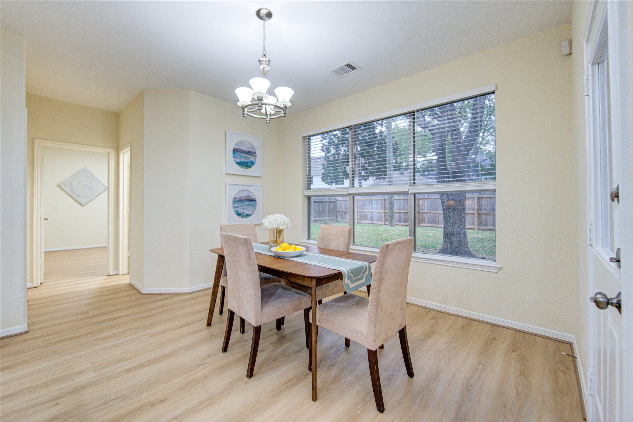 2327 Centerbrook Lane Katy, TX 77450 - Photo 19 of 47 a view of a dining room with furniture a chandelier and wooden floor