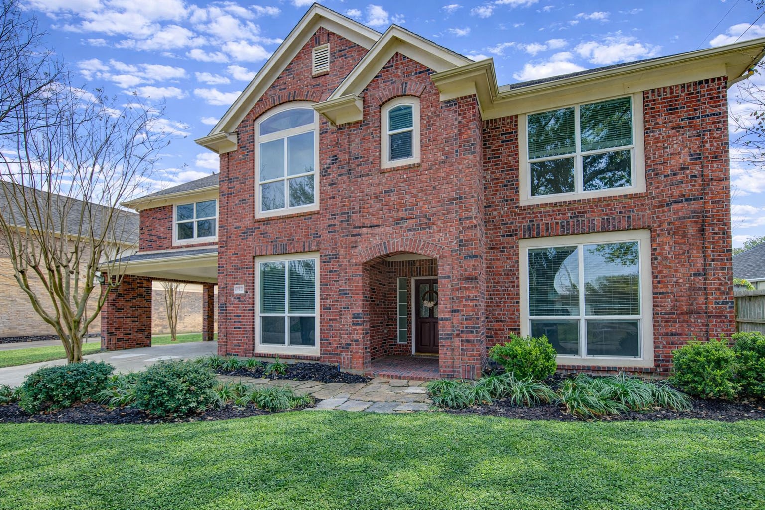 2327 Centerbrook Lane Katy, TX 77450 - Photo 2 of 47 a front view of a house with a yard and plants