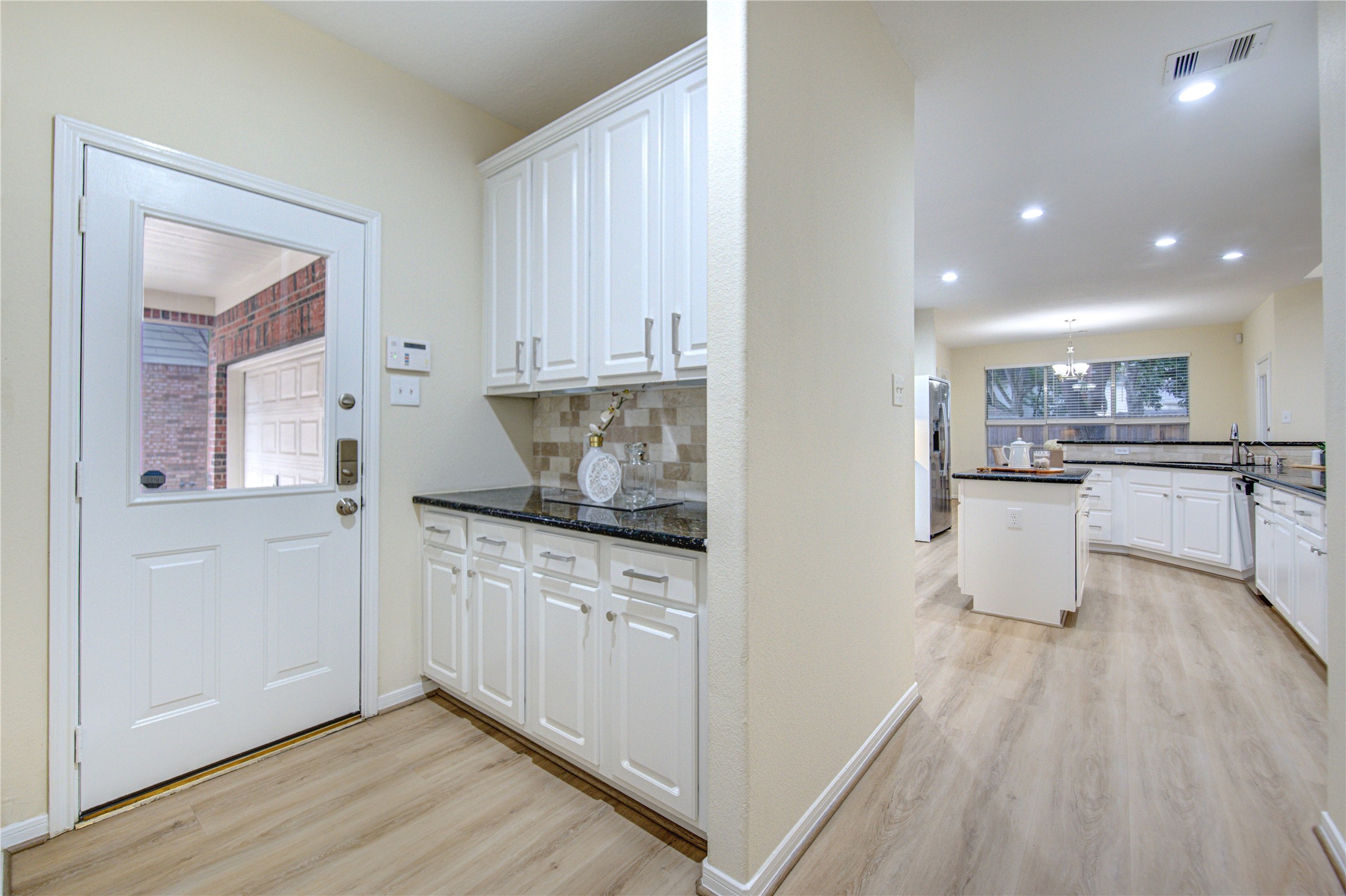 2327 Centerbrook Lane Katy, TX 77450 - Photo 9 of 47 a kitchen with stainless steel appliances granite countertop a refrigerator a sink dishwasher and white cabinets with wooden floor