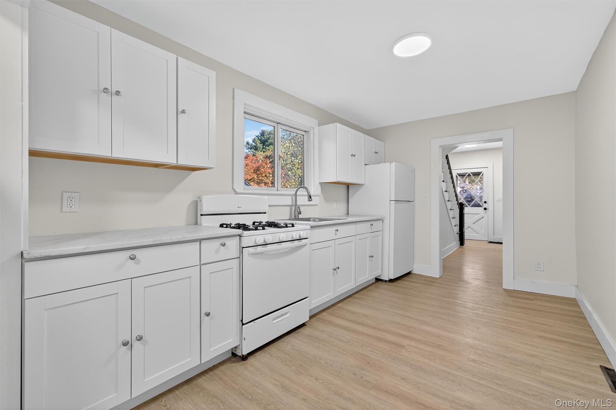 26 Ridge Street Middletown, NY 10940 - Photo 12 of 22 a kitchen with white cabinets and sink