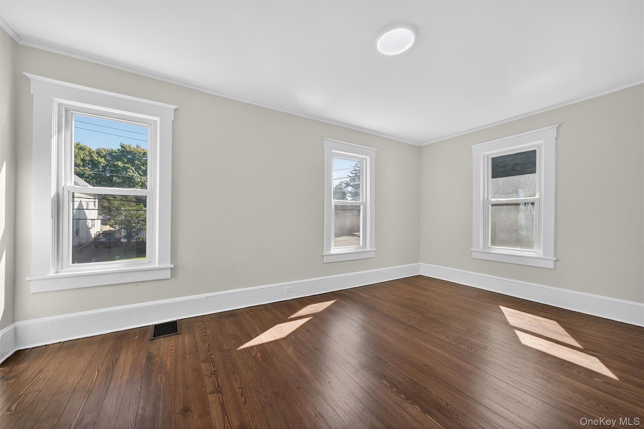26 Ridge Street Middletown, NY 10940 - Photo 14 of 22 a view of an empty room with wooden floor and a window