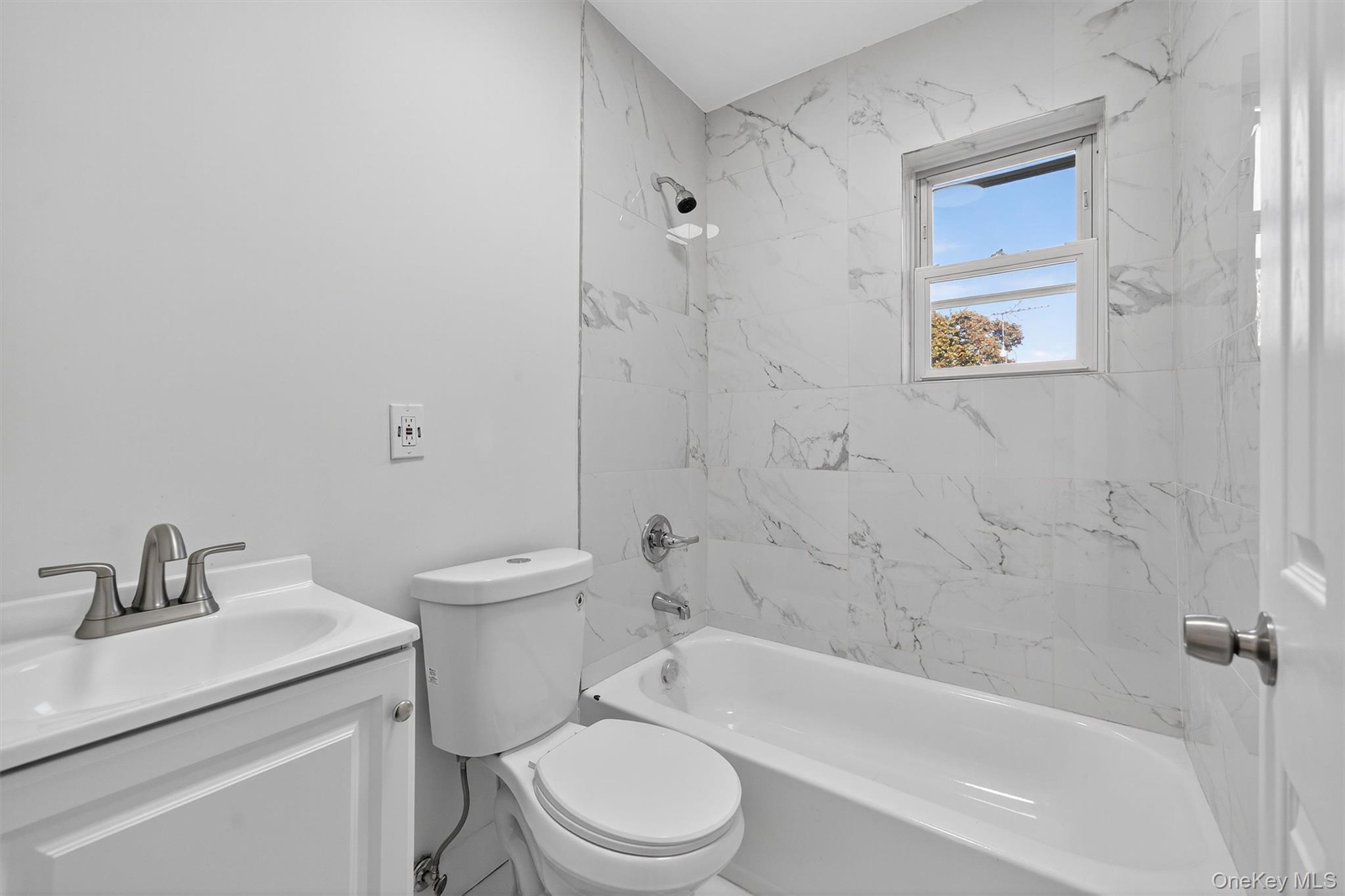 26 Ridge Street Middletown, NY 10940 - Photo 16 of 22 a bathroom with a sink toilet and bathtub