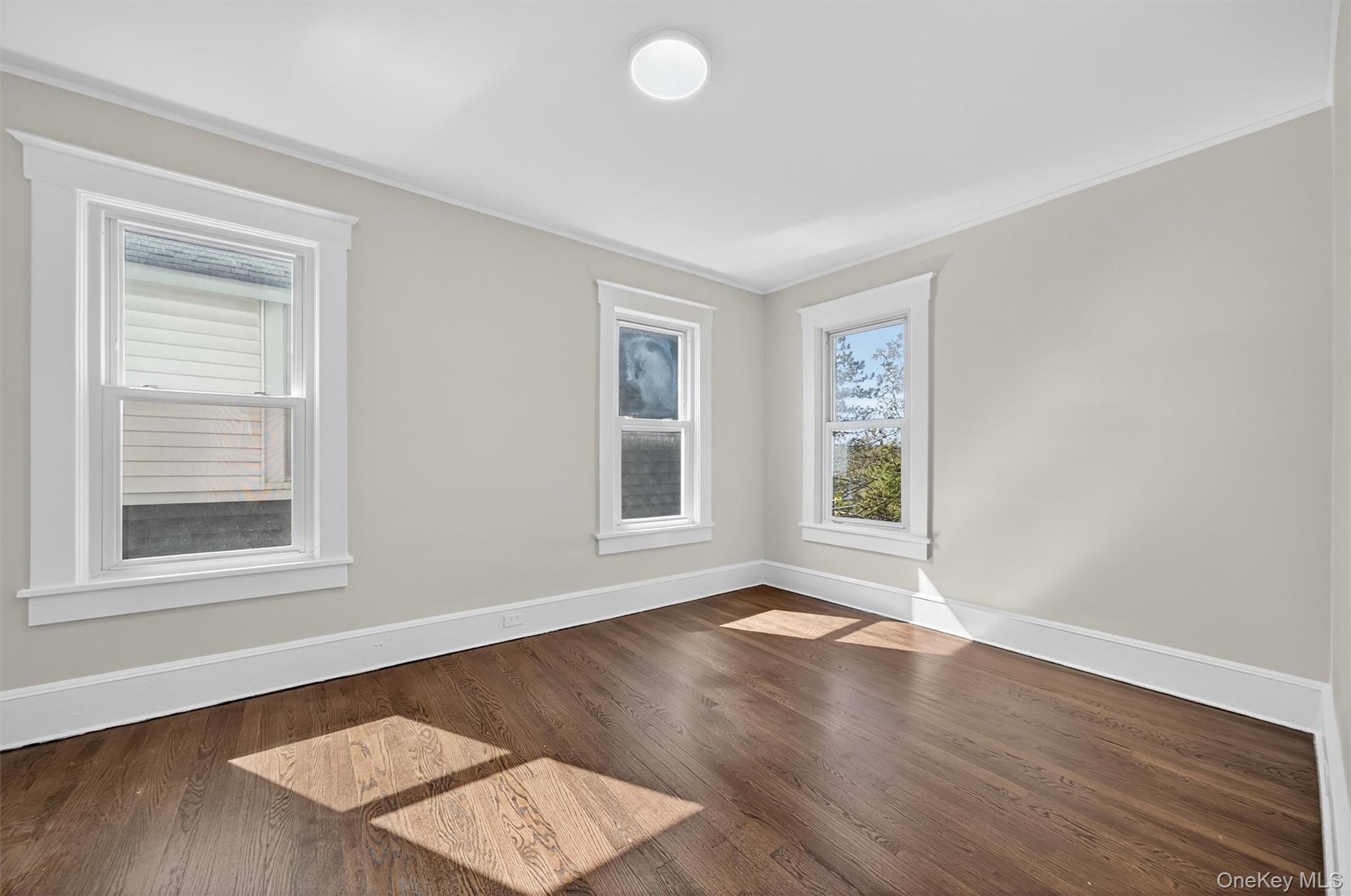 26 Ridge Street Middletown, NY 10940 - Photo 17 of 22 a view of an empty room with wooden floor and a window