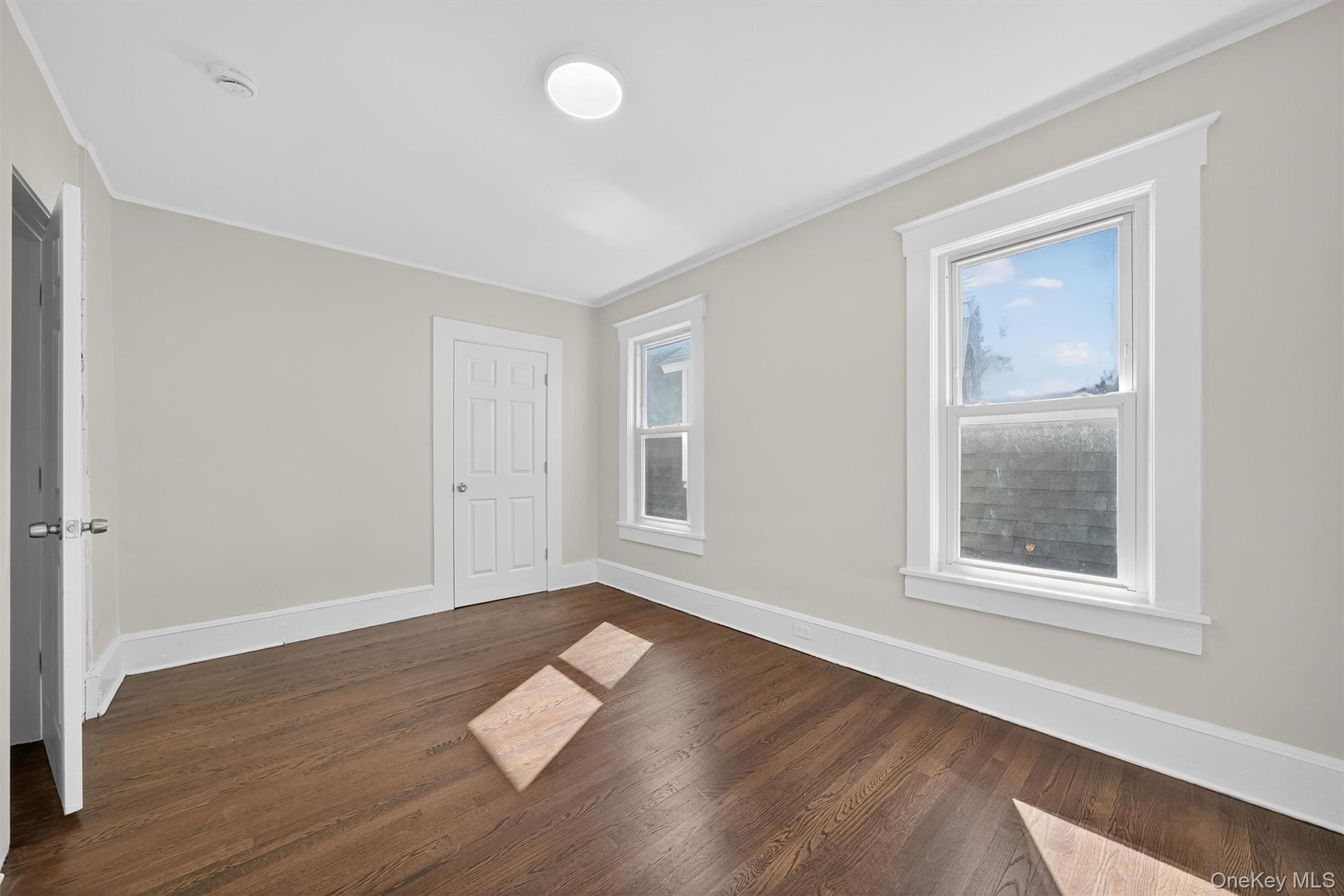 26 Ridge Street Middletown, NY 10940 - Photo 18 of 22 a view of an empty room with wooden floor and a window