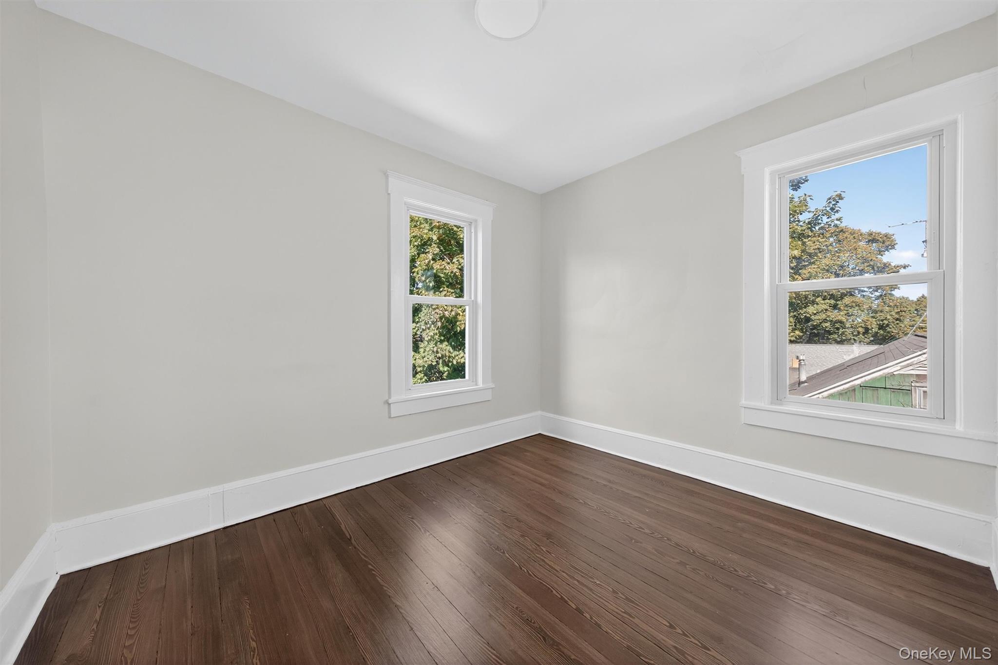 26 Ridge Street Middletown, NY 10940 - Photo 19 of 22 a view of an empty room with wooden floor and a window