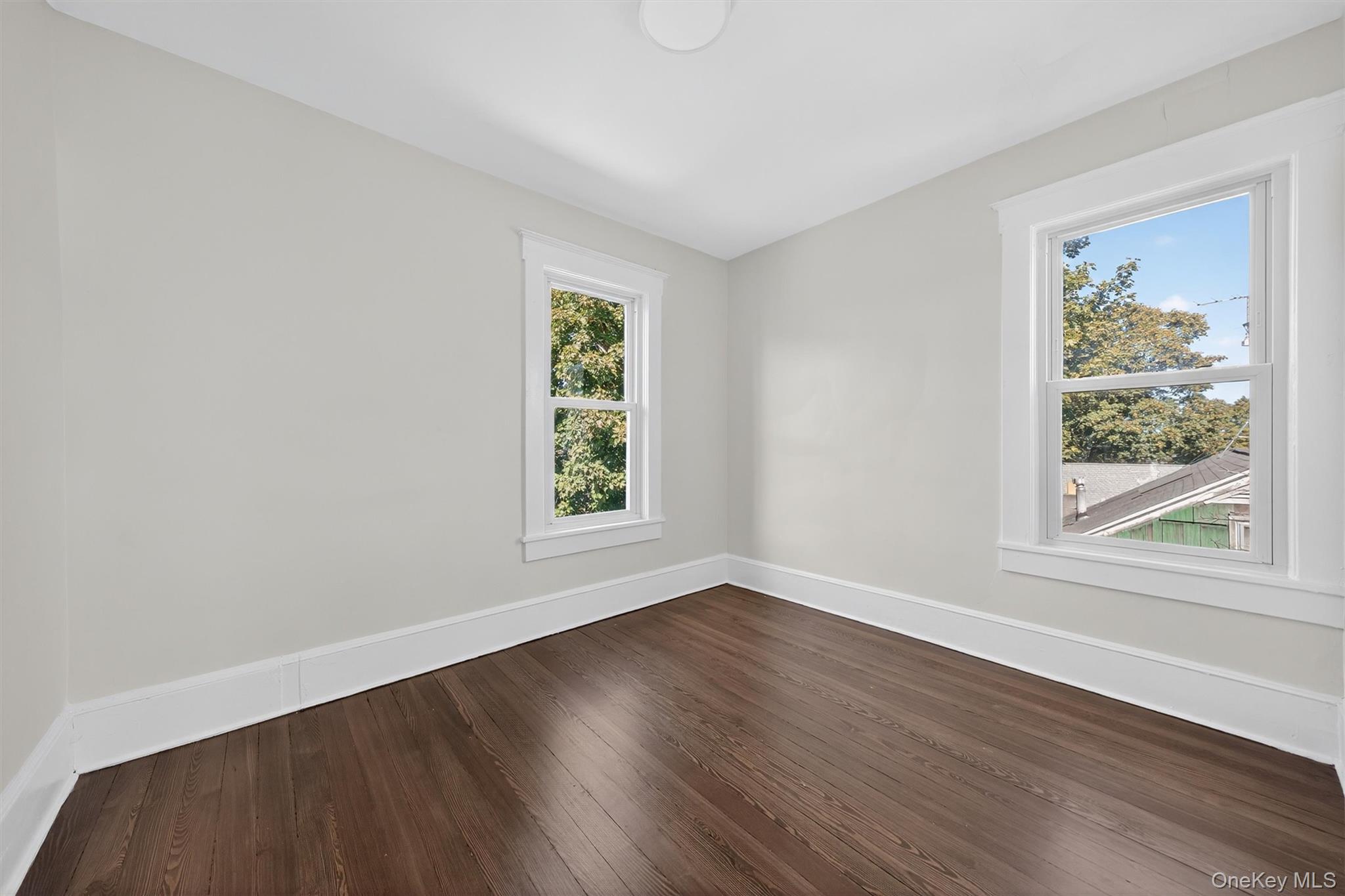 26 Ridge Street Middletown, NY 10940 - Photo 20 of 22 a view of an empty room with wooden floor and a window