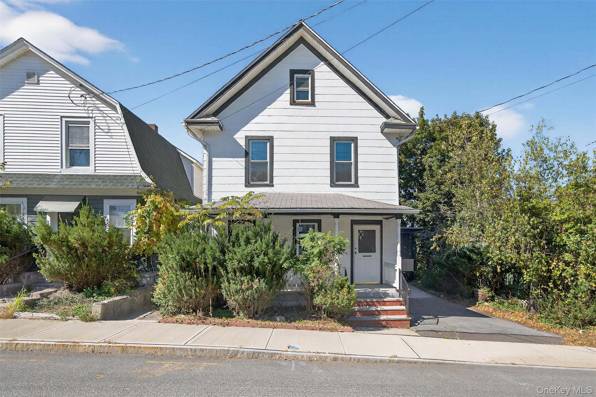 26 Ridge Street Middletown, NY 10940 - Photo 2 of 22 a front view of a house with a garden