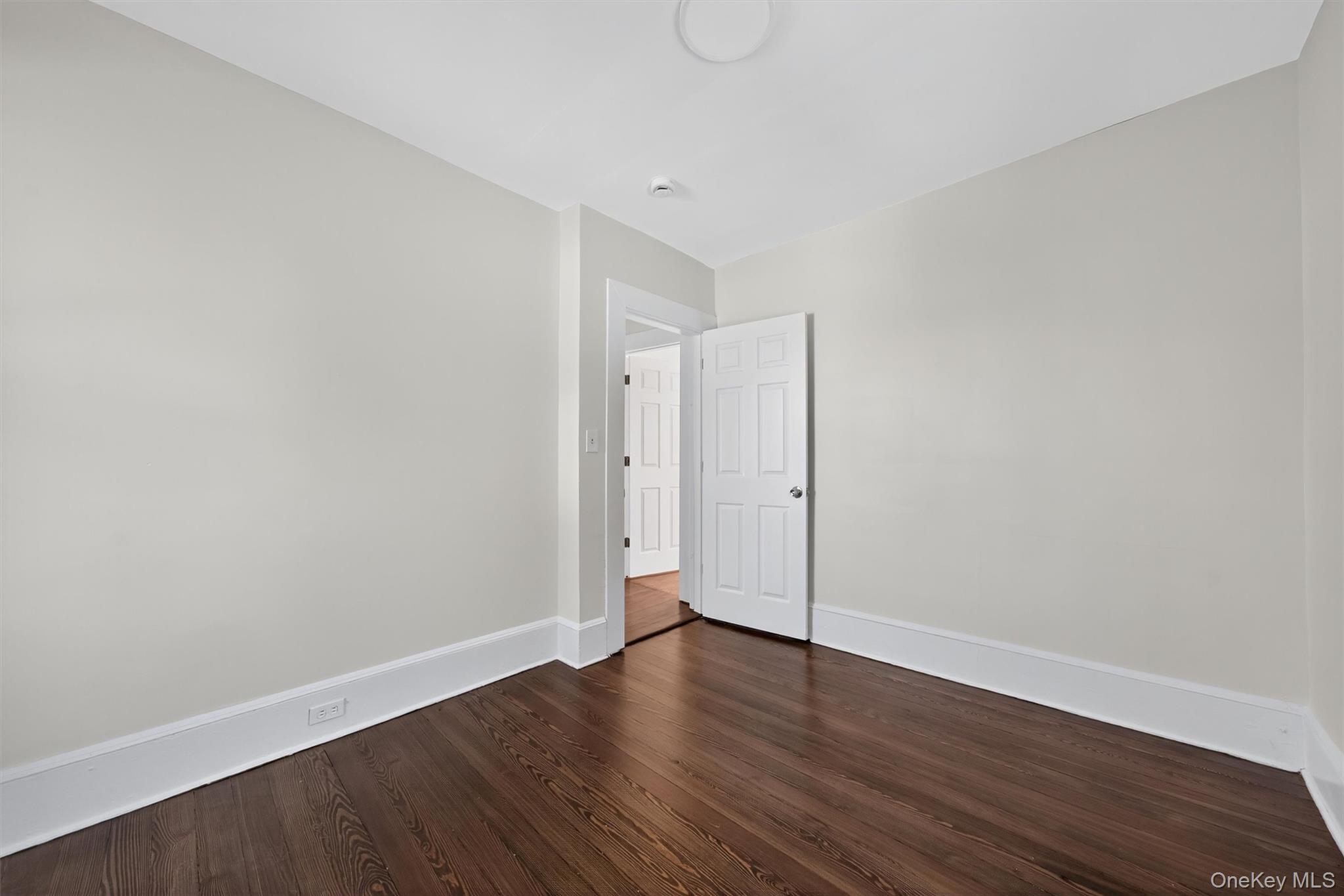 26 Ridge Street Middletown, NY 10940 - Photo 21 of 22 a view of an empty room with wooden floor