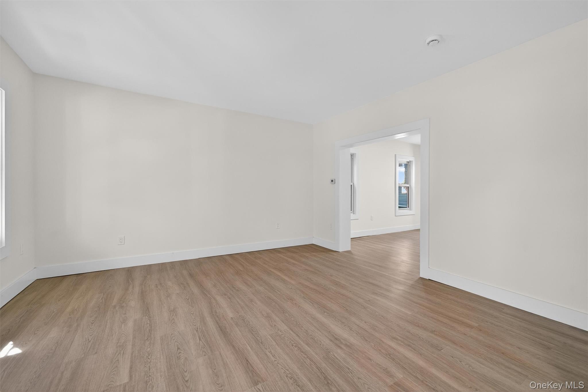 26 Ridge Street Middletown, NY 10940 - Photo 6 of 22 a view of an empty room and wooden floor