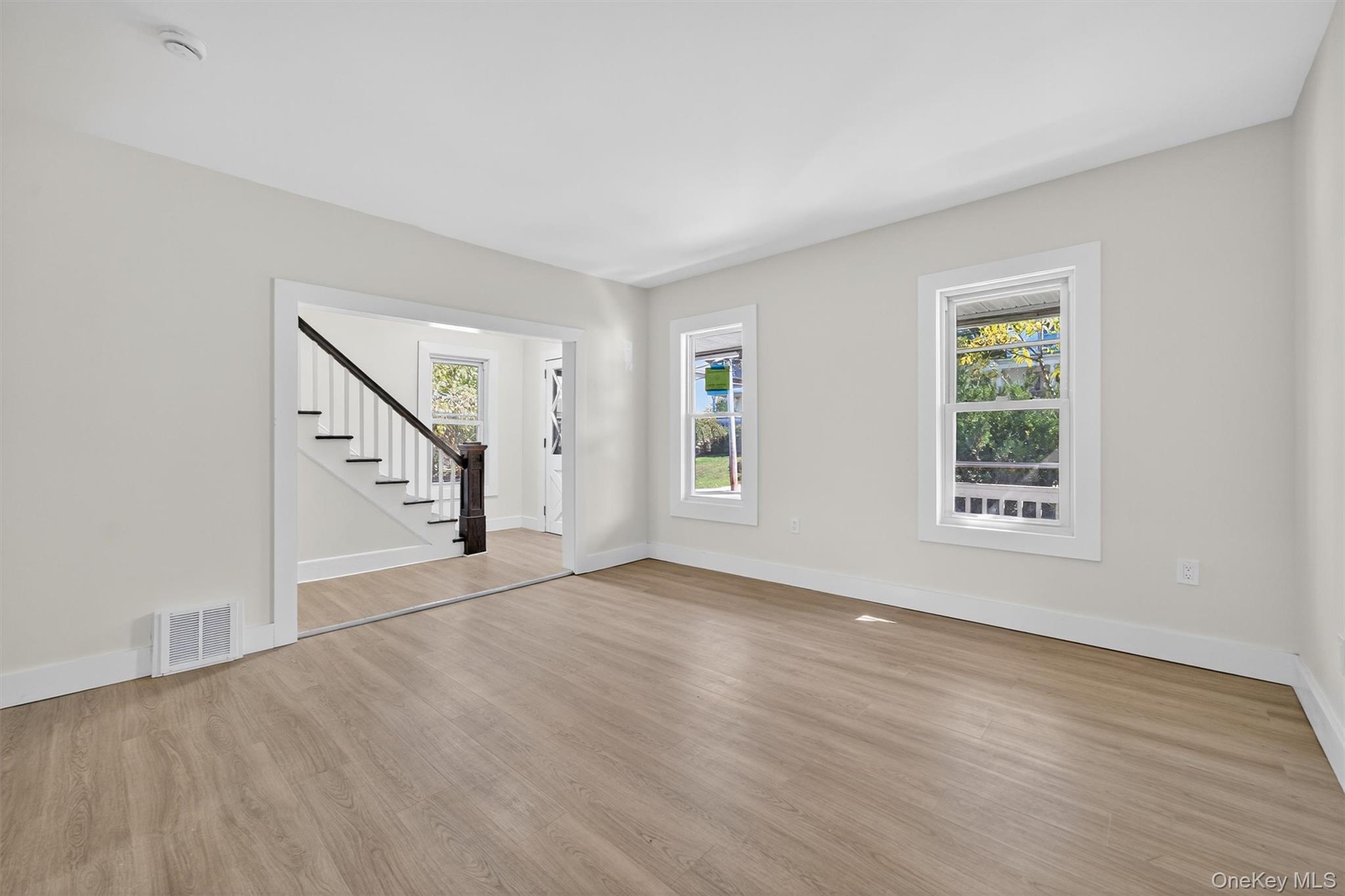 26 Ridge Street Middletown, NY 10940 - Photo 7 of 22 a view of an empty room with wooden floor and a window