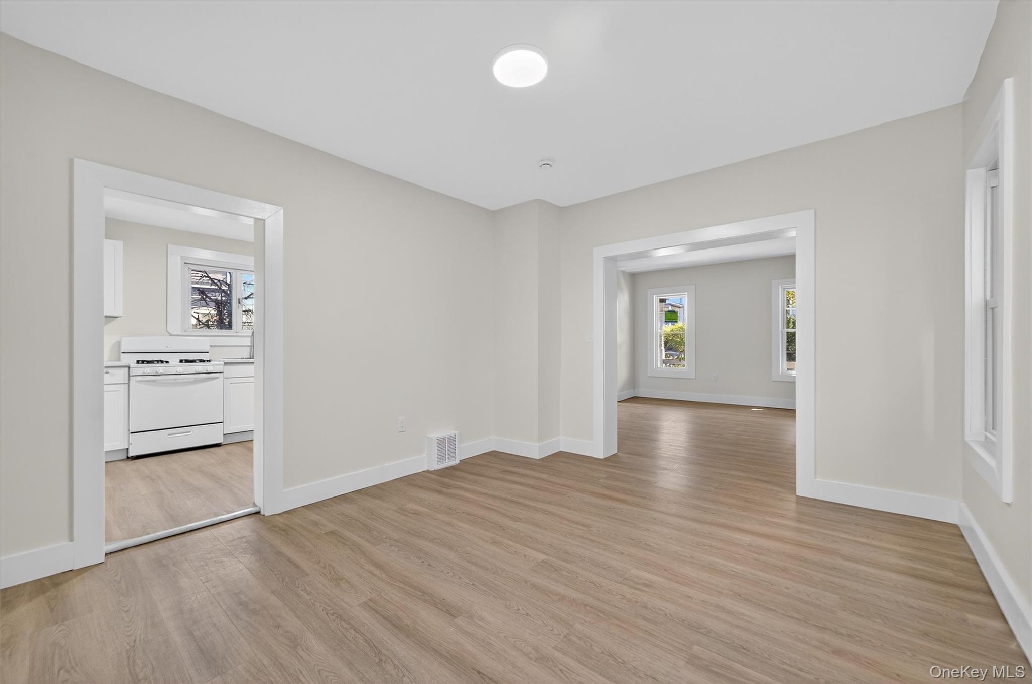 26 Ridge Street Middletown, NY 10940 - Photo 9 of 22 wooden floor in an empty room with a window