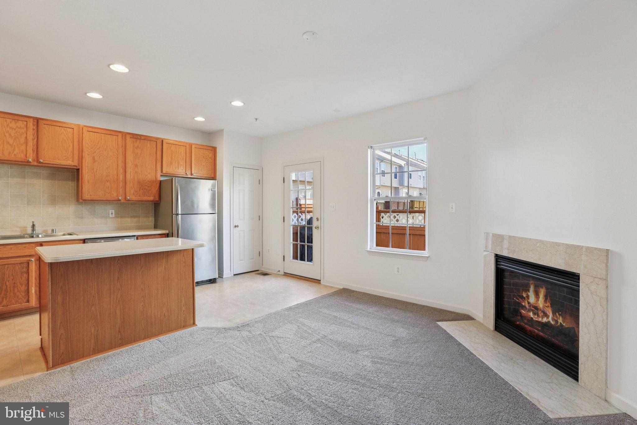 8046 Pennington Drive Laurel, MD 20724 - Photo 7 of 12 a open kitchen with stainless steel appliances granite countertop a refrigerator a stove a sink and a microwave