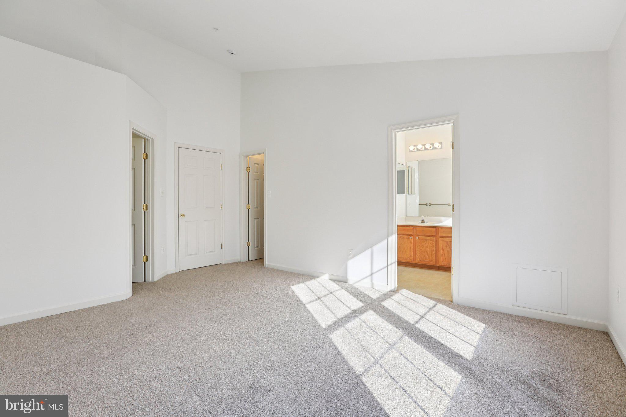 8046 Pennington Drive Laurel, MD 20724 - Photo 8 of 12 a view of a livingroom with wooden floor and a bathroom