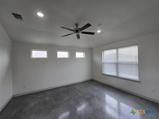 a view of an empty room with a window