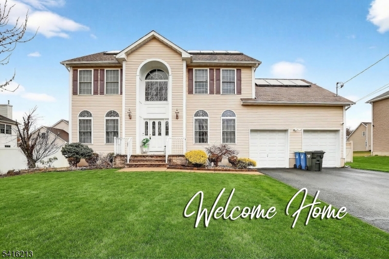 127 Churchill Avenue Somerset, NJ 08873 - Photo 1 of 33 a front view of a house with a garden and pathway