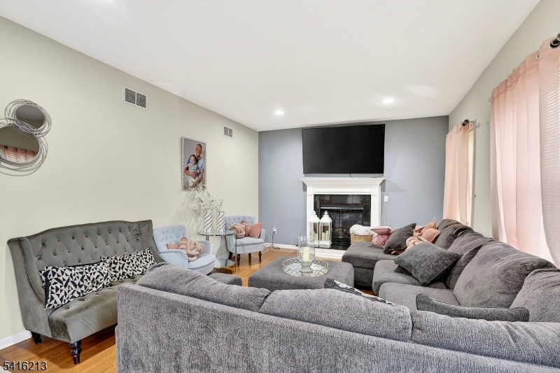 127 Churchill Avenue Somerset, NJ 08873 - Photo 15 of 33 a living room with furniture fireplace and a flat screen tv