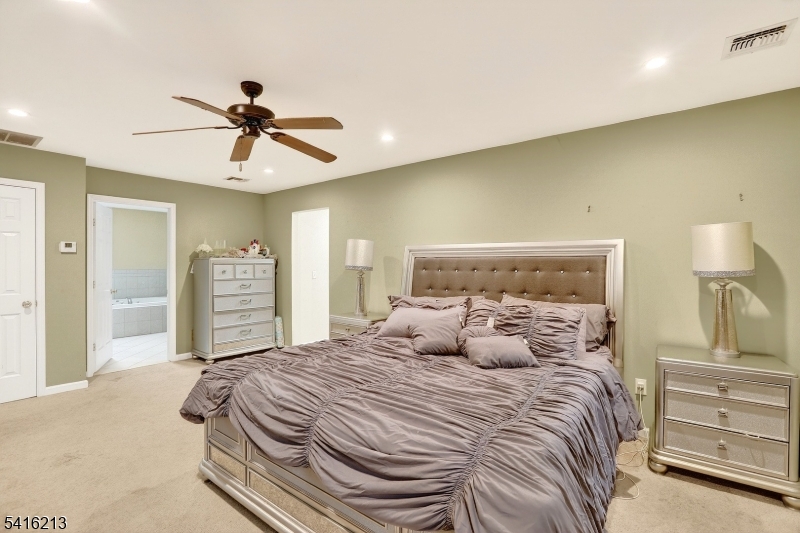 127 Churchill Avenue Somerset, NJ 08873 - Photo 19 of 33 a bedroom with a bed and a chandelier