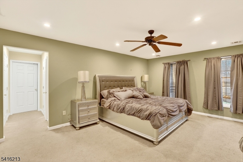 127 Churchill Avenue Somerset, NJ 08873 - Photo 20 of 33 a bedroom with a bed and a chandelier