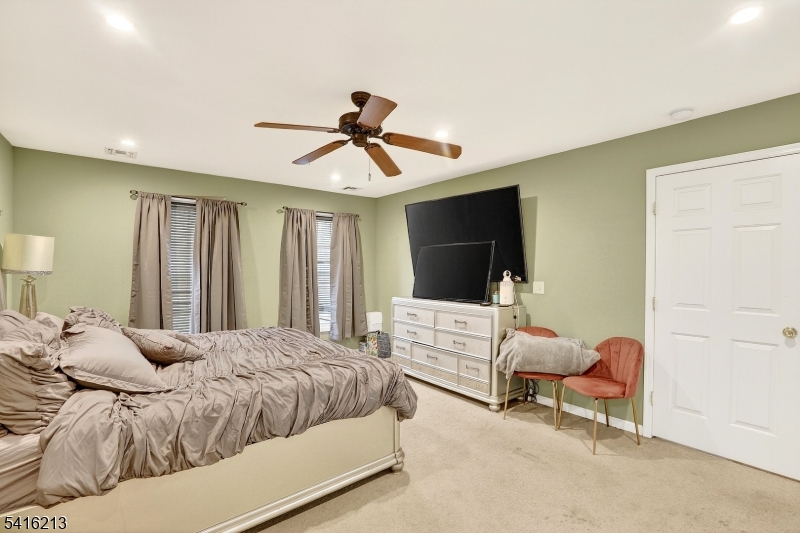 127 Churchill Avenue Somerset, NJ 08873 - Photo 21 of 33 a bedroom with a bed and a chandelier