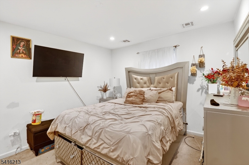 127 Churchill Avenue Somerset, NJ 08873 - Photo 24 of 33 a bedroom with a bed and a flat screen tv