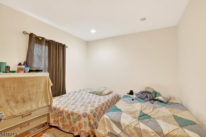 127 Churchill Avenue Somerset, NJ 08873 - Photo 27 of 33 a bedroom with a bed and a refrigerator