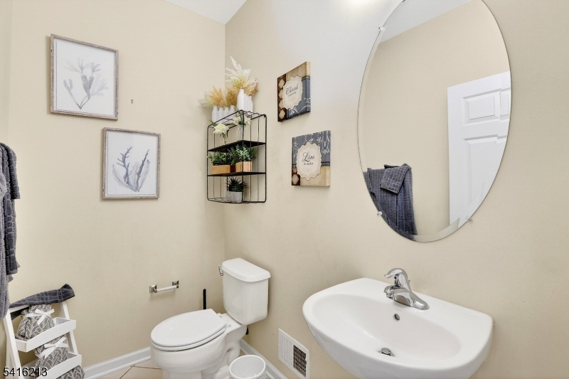 127 Churchill Avenue Somerset, NJ 08873 - Photo 30 of 33 a bathroom with a toilet sink and mirror
