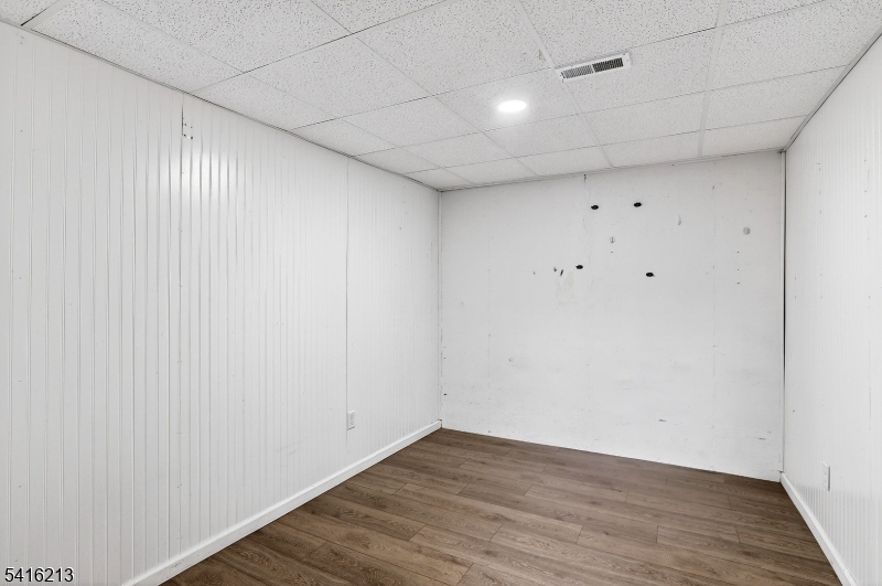 127 Churchill Avenue Somerset, NJ 08873 - Photo 33 of 33 a view of an empty room with wooden floor