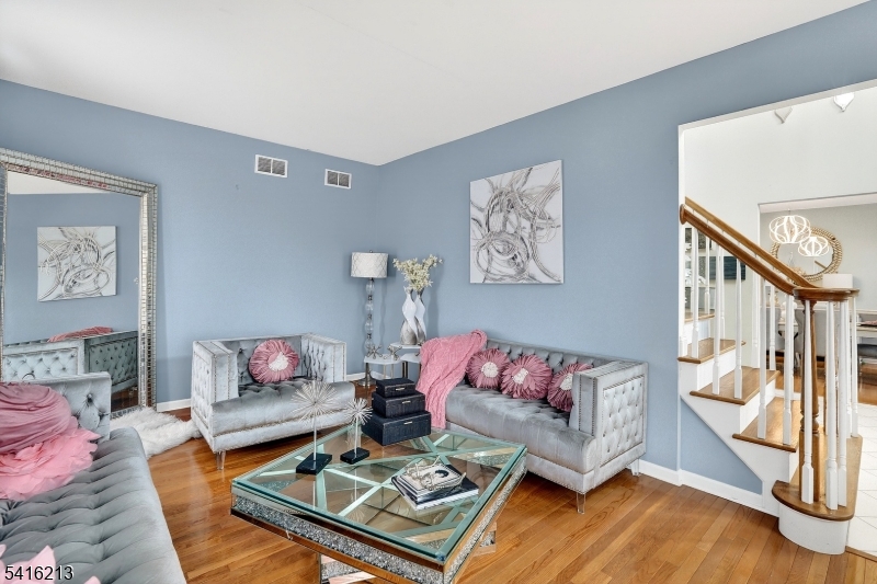 127 Churchill Avenue Somerset, NJ 08873 - Photo 8 of 33 a living room with furniture and wooden floor