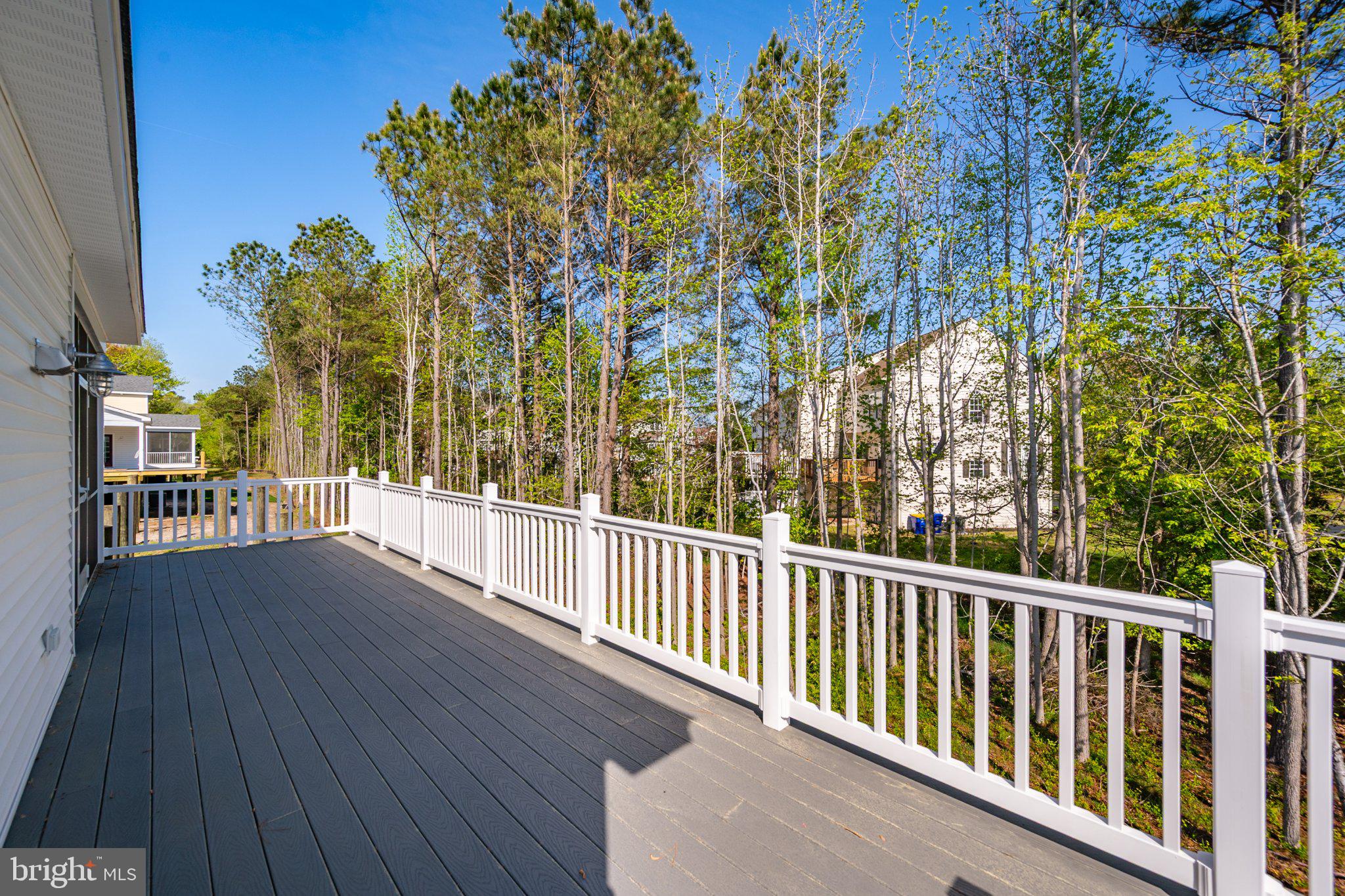 36047 Jackson Street Ocean View, DE 19970 - Photo 42 of 50 Serene deck with lush green backdrop.