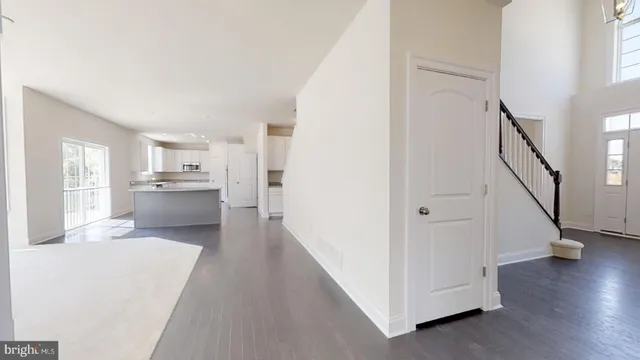 an empty room with windows and fireplace