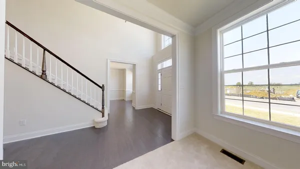 a view of an entryway with wooden floor